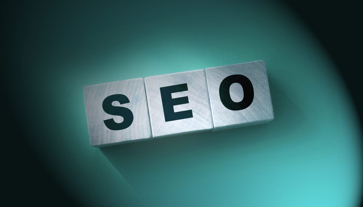 Seo concept. Wooden cubes on red. Search Engine Optimization.